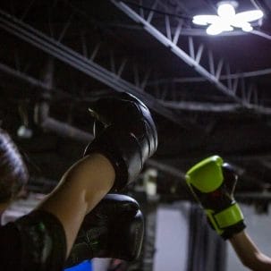 Programs 5 Raw Kickboxing and Fitness Teens Raising Boxing Gloves
